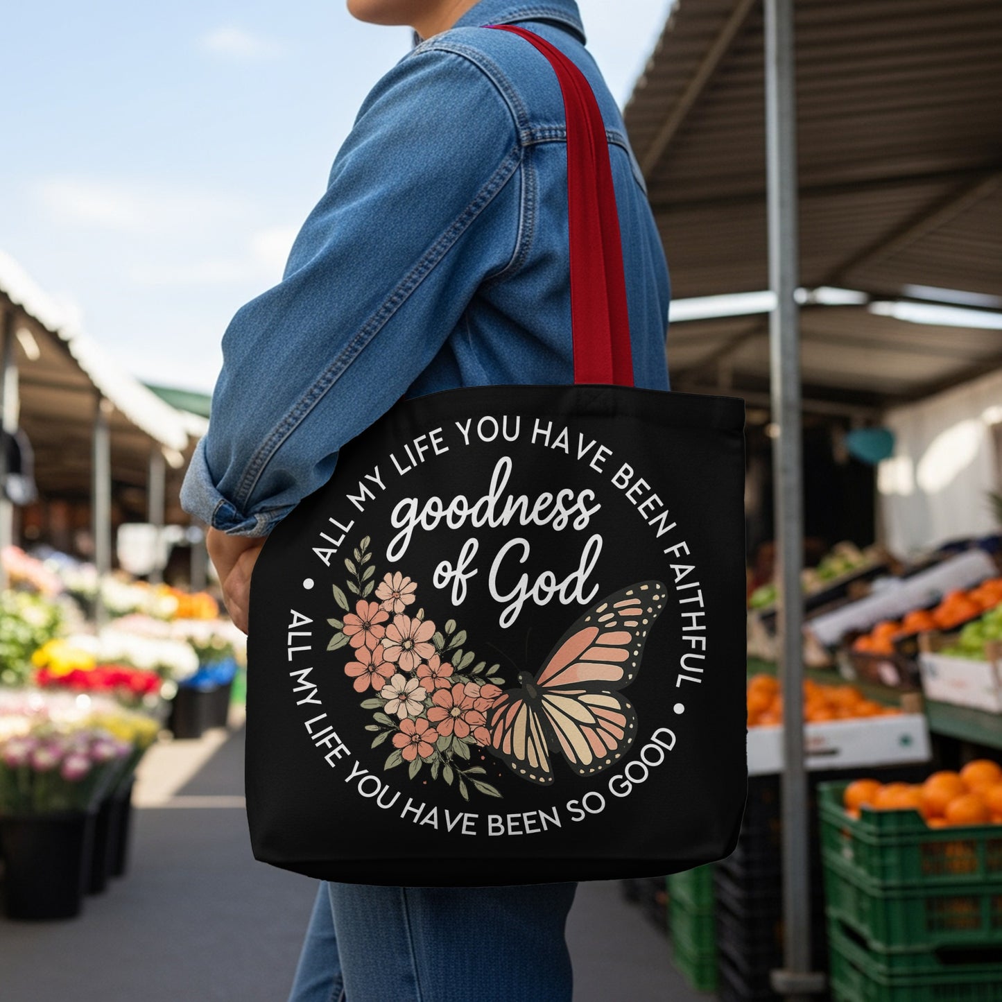 Black tote bag with text "goodness of God" and floral butterfly design.