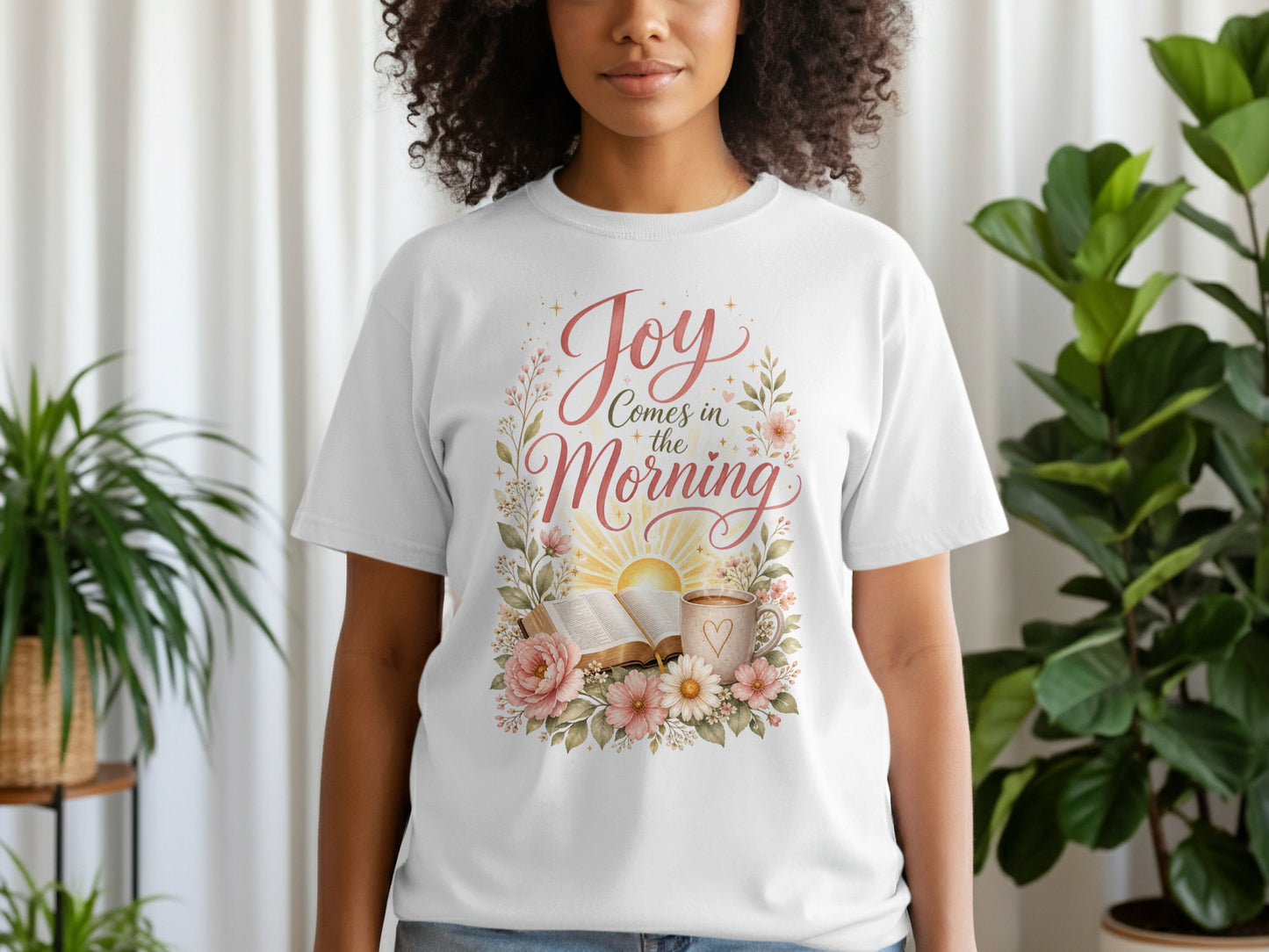 White t-shirt with floral design and text "Joy Comes in the Morning".