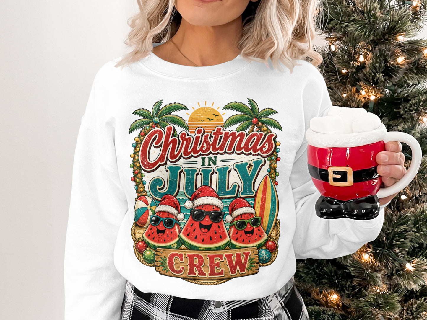 Christmas in July Crew graphic on white sweatshirt with palm trees and sunglasses-wearing watermelons.