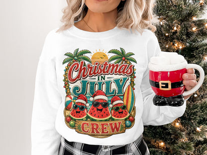 Christmas in July Crew graphic on white sweatshirt with palm trees and sunglasses-wearing watermelons.