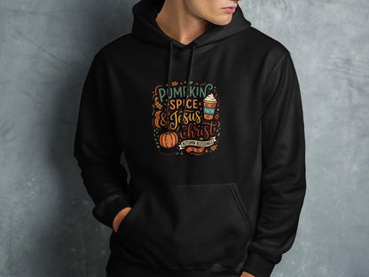 Black hoodie with colorful text "Pumpkin Spice & Jesus" and autumn accents.