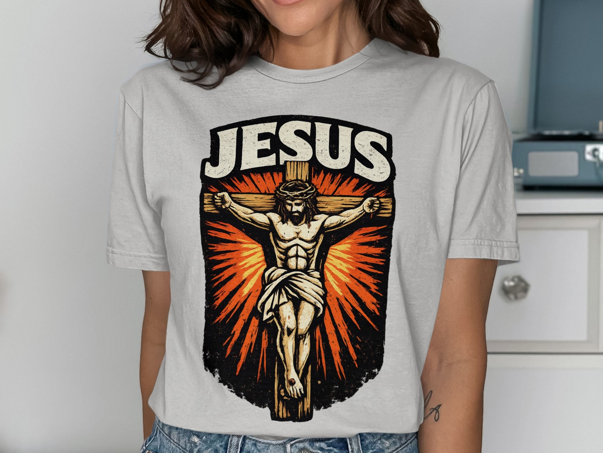 Jesus Christ on the cross design on a light gray t-shirt.