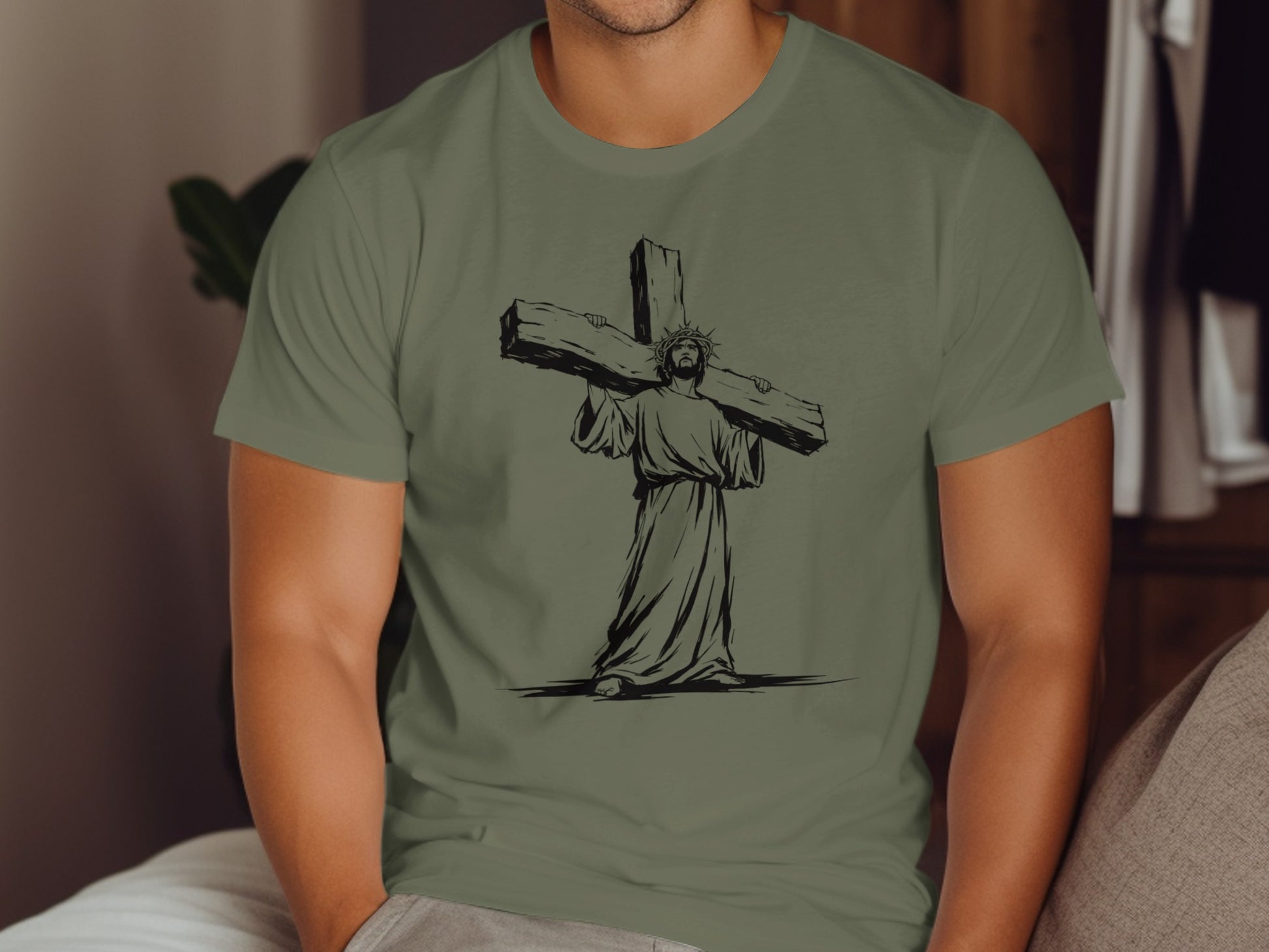 Jesus carrying a large wooden cross, illustration on an olive green t-shirt.