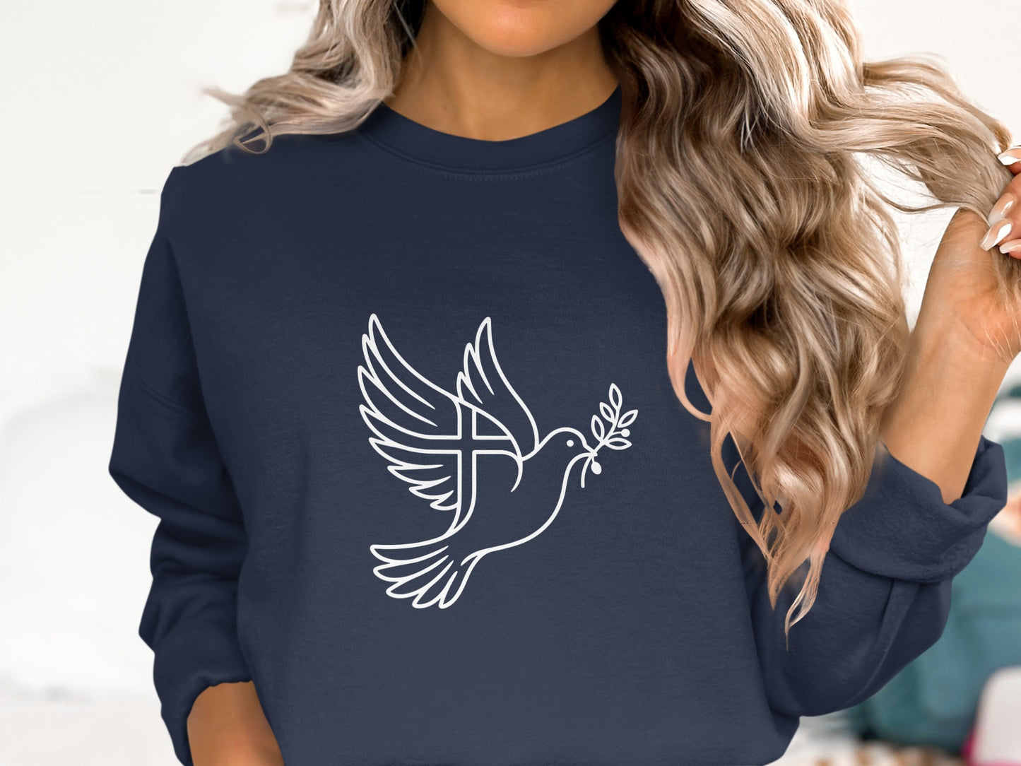 Navy sweatshirt with white dove carrying olive branch and cross design.