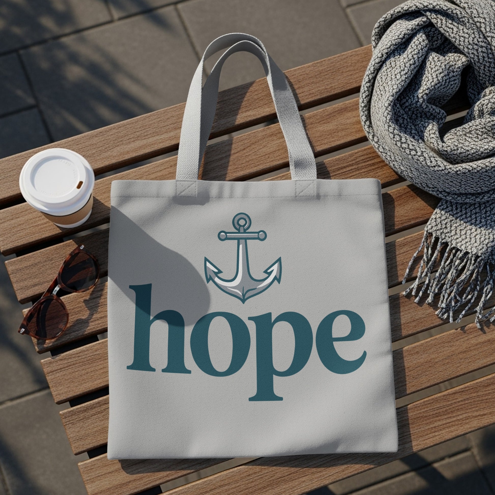 Light grey tote bag with anchor graphic and "hope" text on a wooden bench.