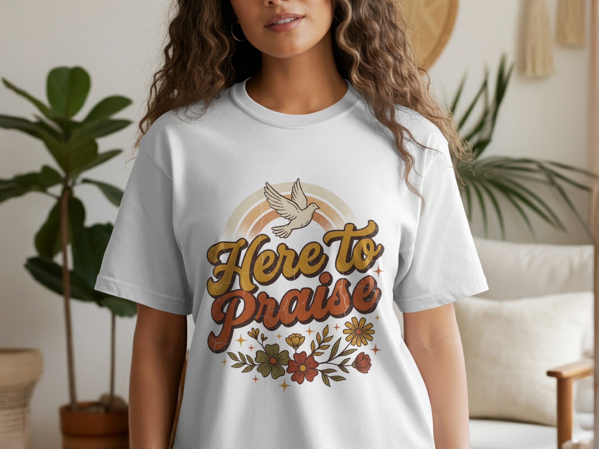 White t-shirt with "Here to Praise" text, a dove, rainbow, and floral design.
