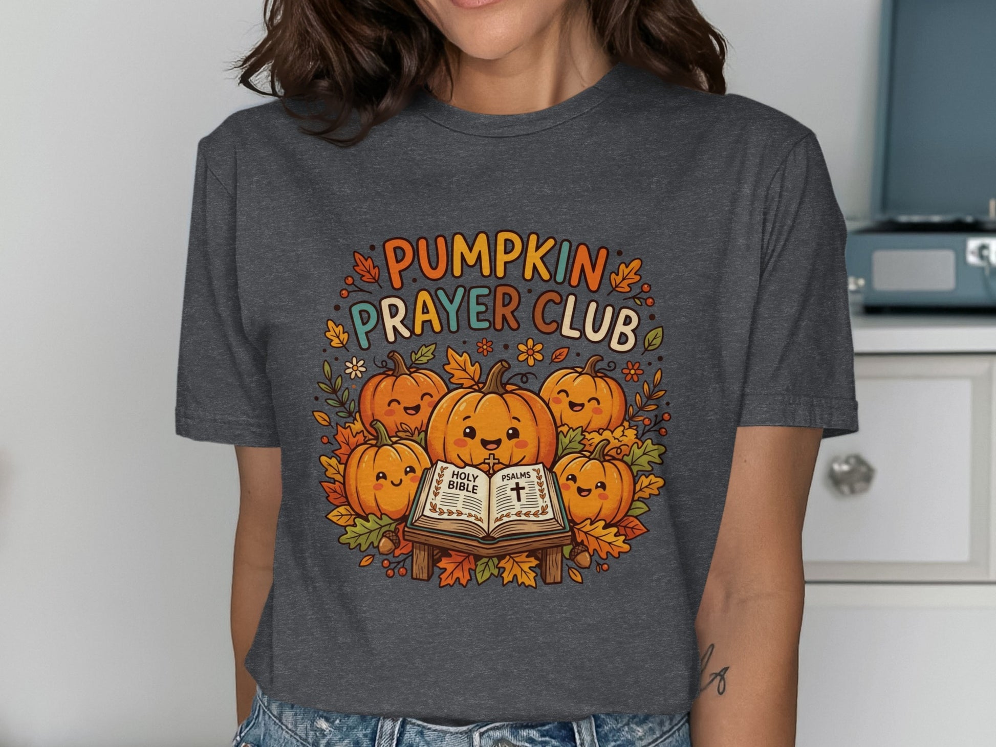 T-shirt featuring pumpkins, autumn leaves, and "Pumpkin Prayer Club" text.