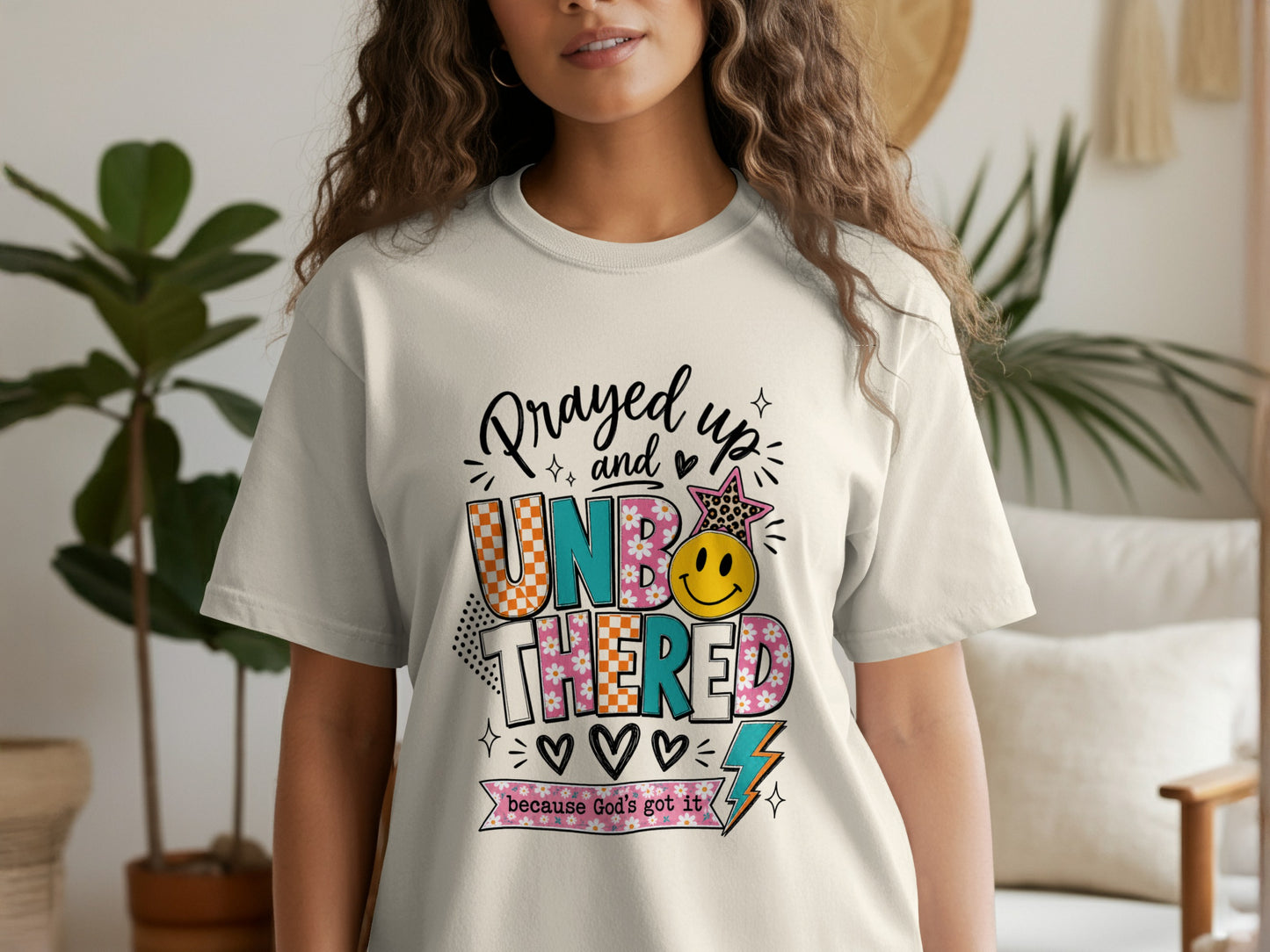 Light cream t-shirt with "Prayed up and UNBOTHERED because God's got it" graphic.