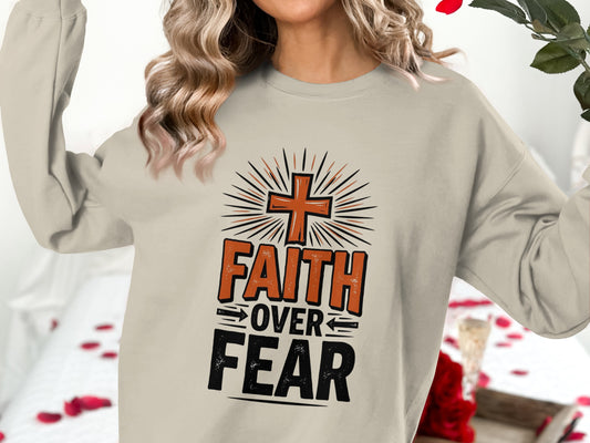 Beige sweatshirt with "FAITH OVER FEAR" graphic and cross design.
