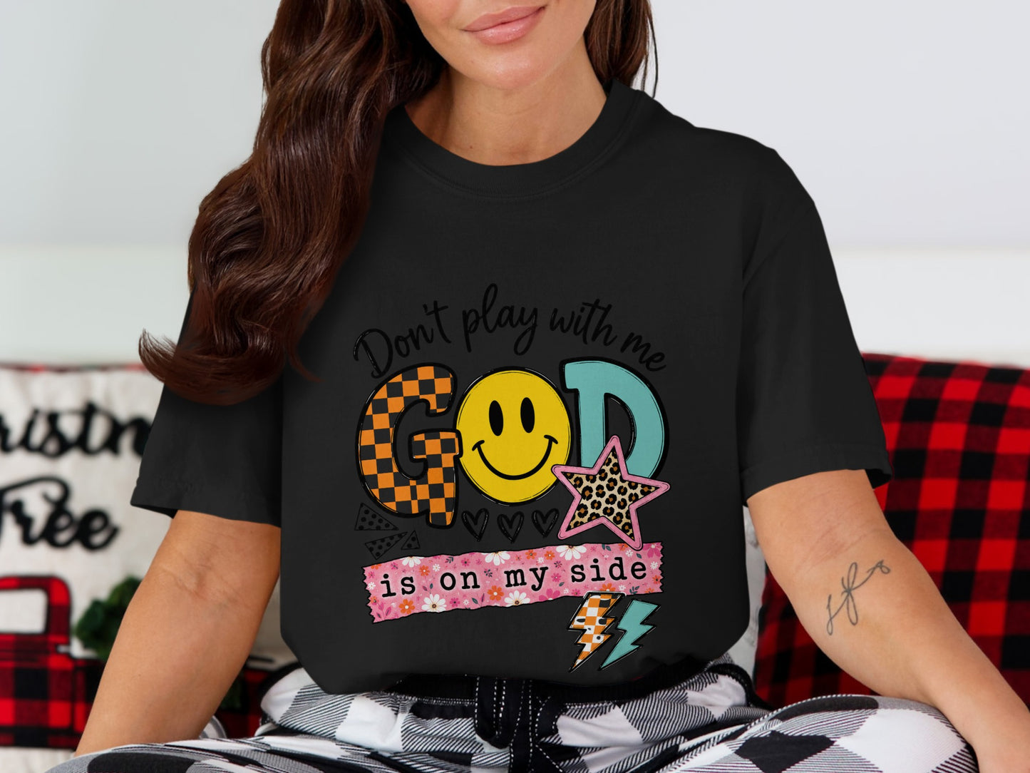 Black t-shirt with "God is on my side" and smiley face graphic.