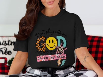 Black t-shirt with "God is on my side" and smiley face graphic.