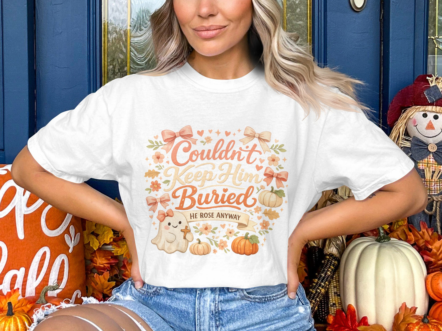 White t-shirt with "Couldn't Keep Him Buried, He Rose Anyway" graphic featuring a ghost.