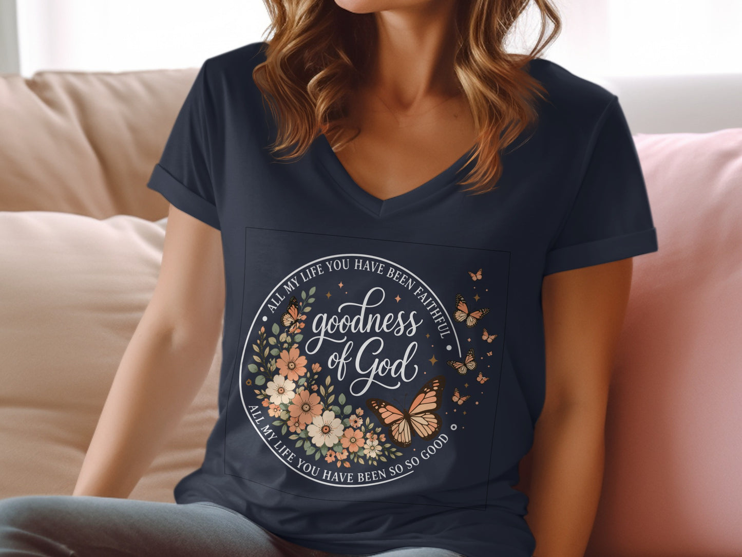 V-neck t-shirt with floral wreath and butterflies, featuring text "goodness of God".