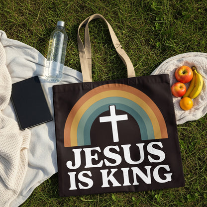 Black tote bag with rainbow and cross design, reads "Jesus Is King".