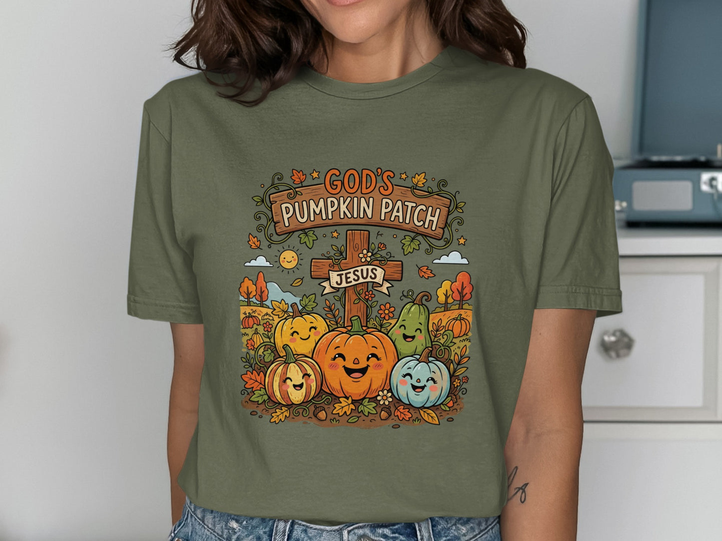 God's Pumpkin Patch Jesus shirt with smiling pumpkins and autumn leaves.