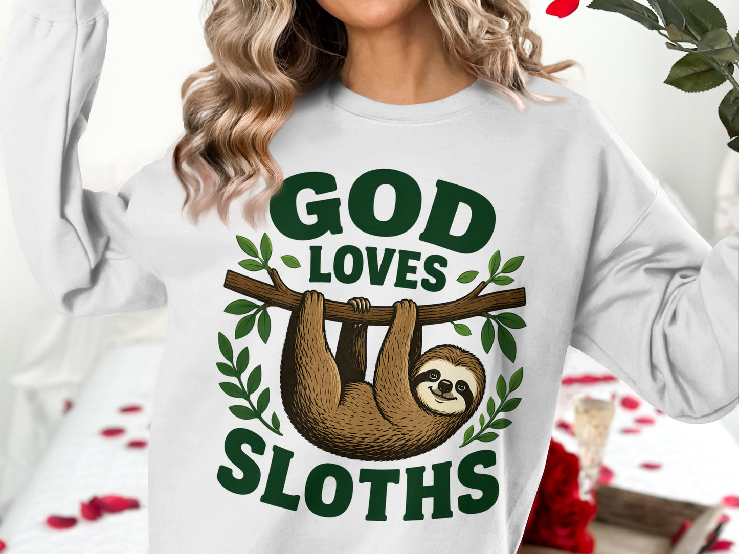 White sweatshirt with "God Loves Sloths" graphic and sloth hanging from branch.