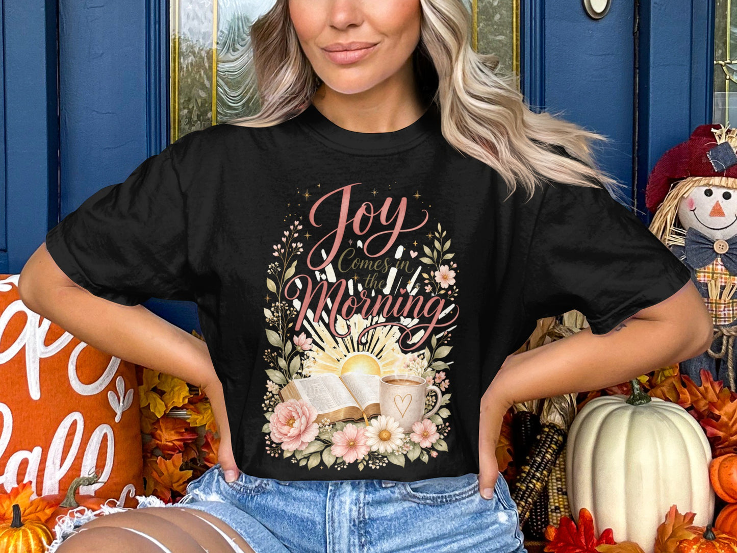 Black t-shirt with "Joy Comes in the Morning" floral design, open book, and coffee mug.
