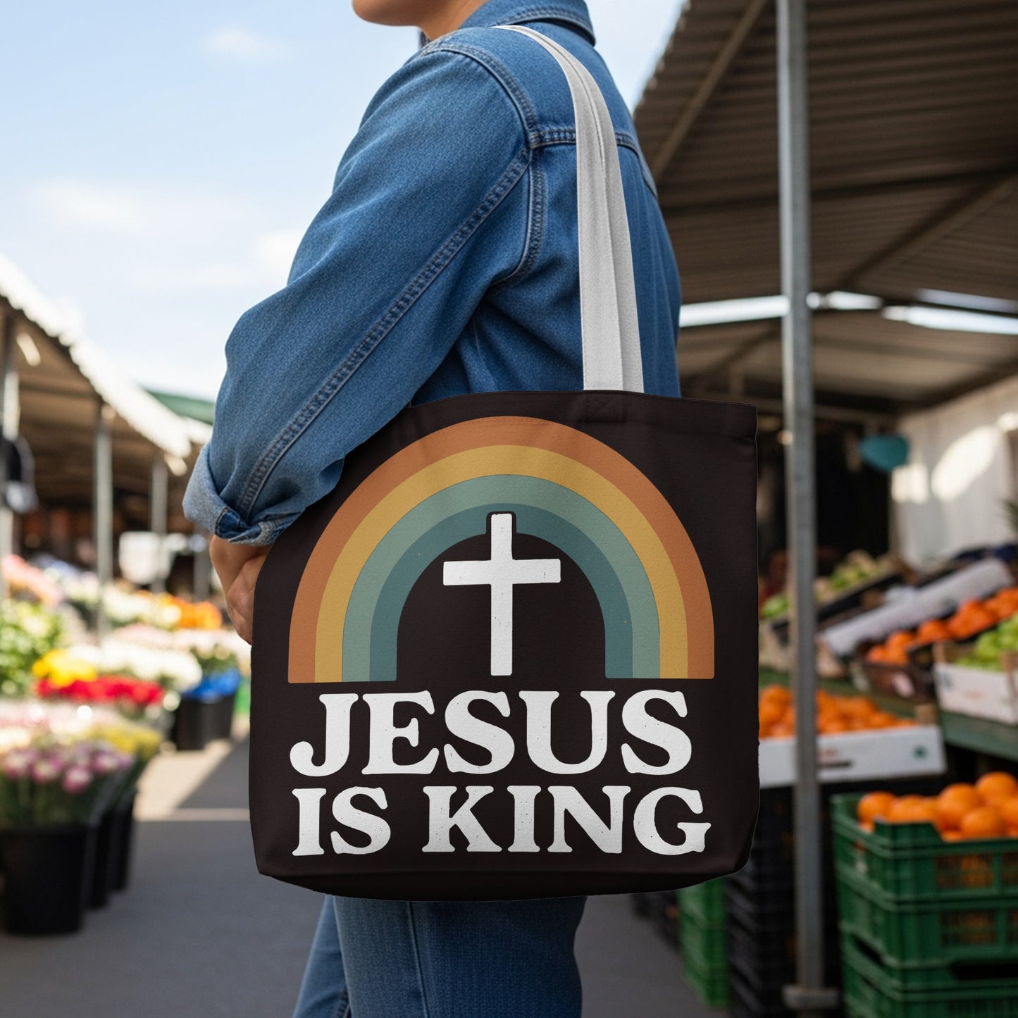 Tote bag with rainbow and cross design saying "JESUS IS KING".