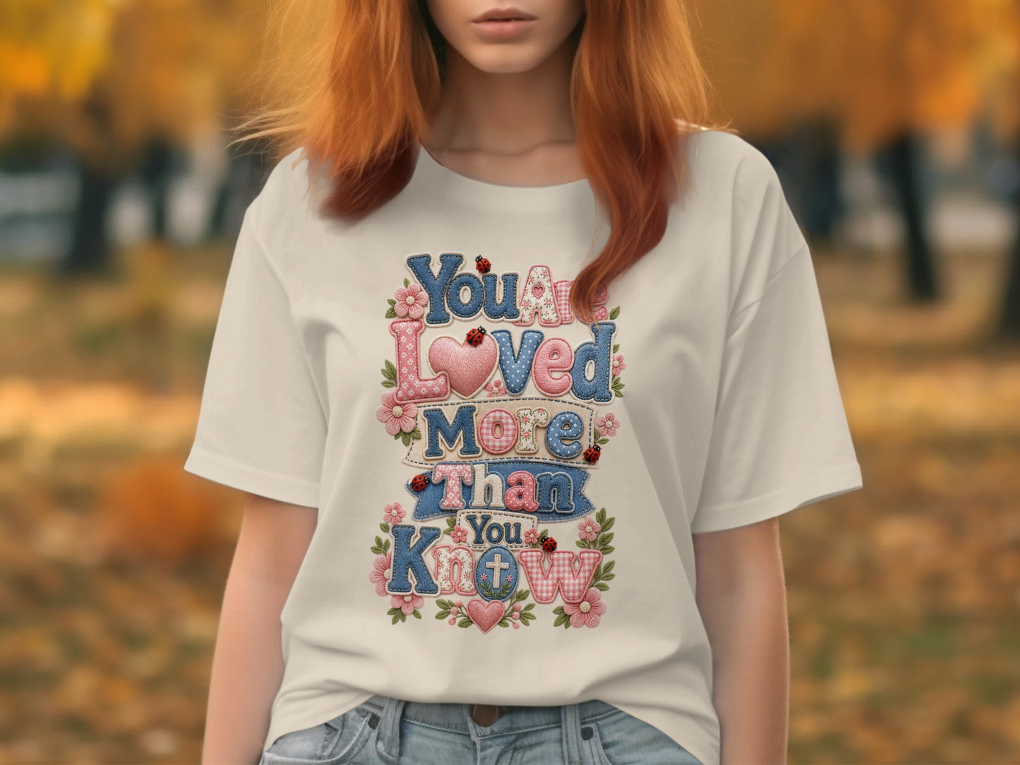 T-shirt with "You Are Loved More Than You Know" text, hearts, and ladybugs.
