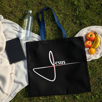 Black tote bag with white and red "Jesus" text and graphic.