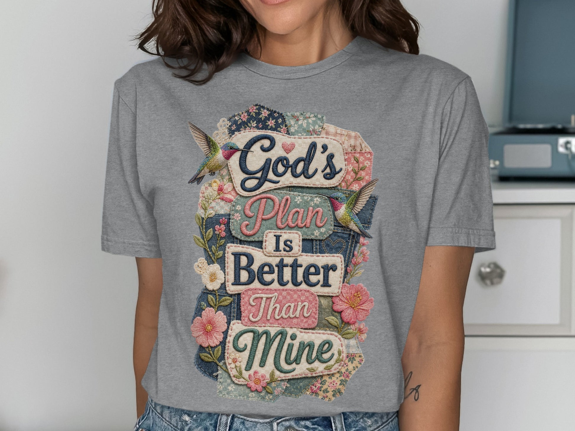 God's Plan Is Better Than Mine text with floral and hummingbird accents on t-shirt.