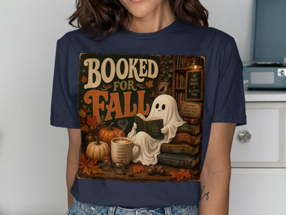 Booked for Fall text with a ghost reading a book, pumpkins, and coffee.