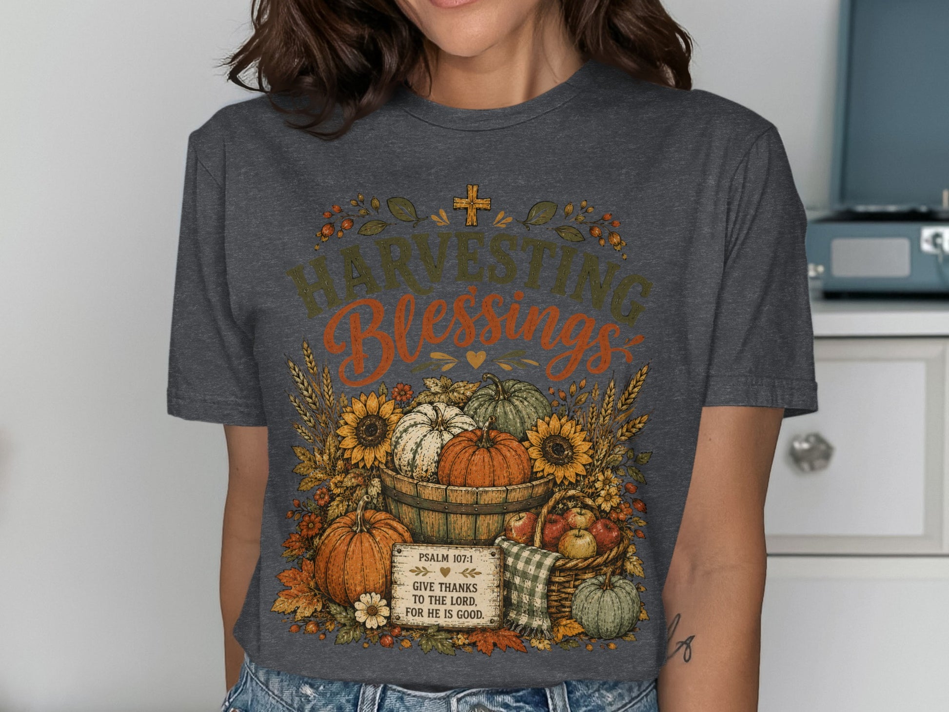 Dark gray t-shirt with "Harvesting Blessings" and autumn harvest illustration.