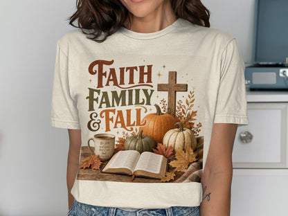 Cream shirt with "Faith Family & Fall" text, pumpkins, cross, book, and mug.