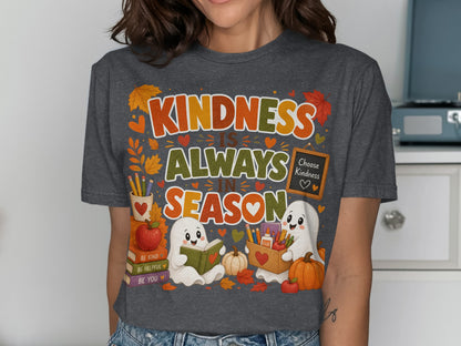 T-shirt graphic with ghosts, books, and pumpkins saying "Kindness is always in season."