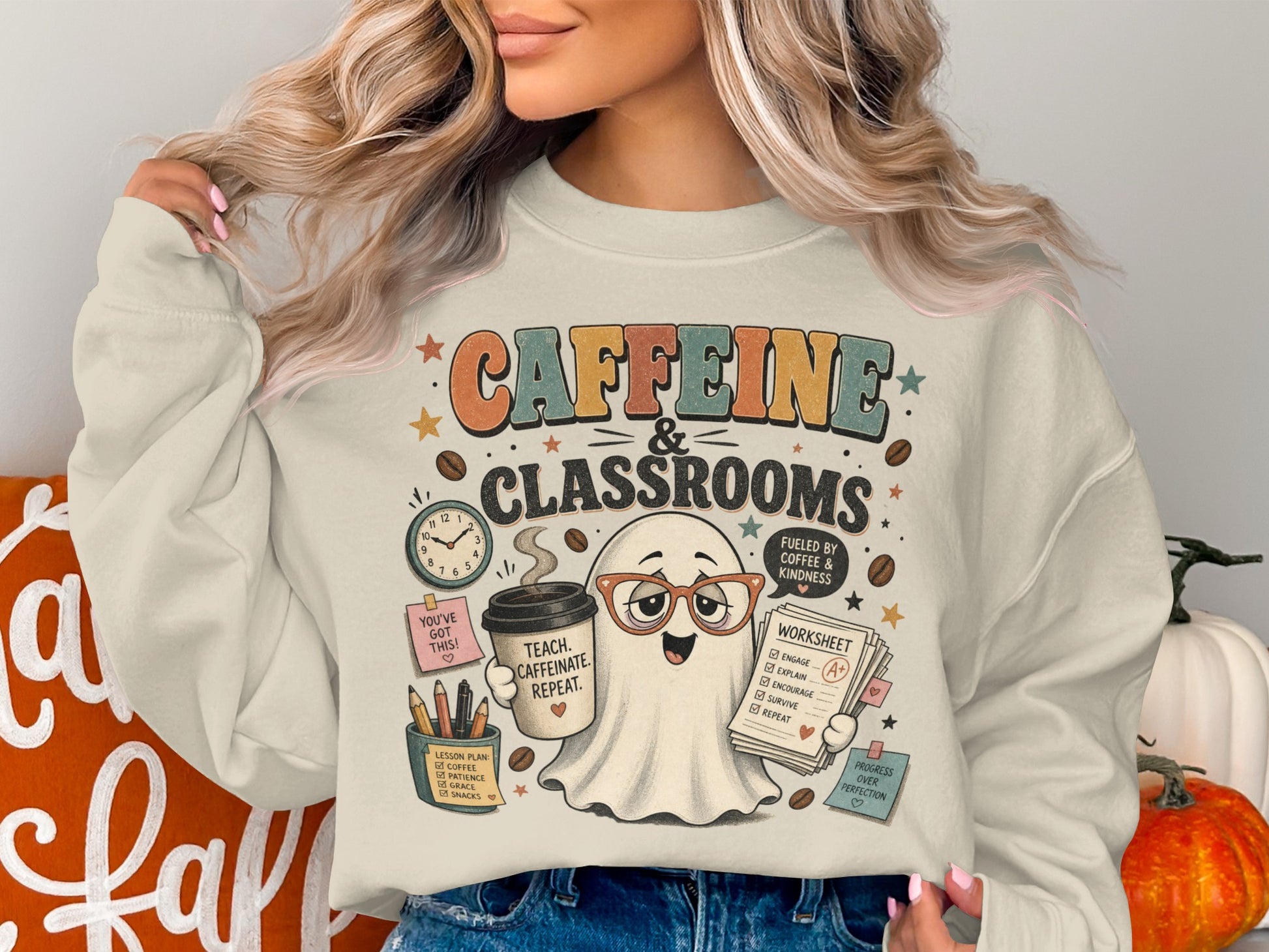 Ghost graphic on sweatshirt with text "Caffeine & Classrooms" and teacher-themed elements.