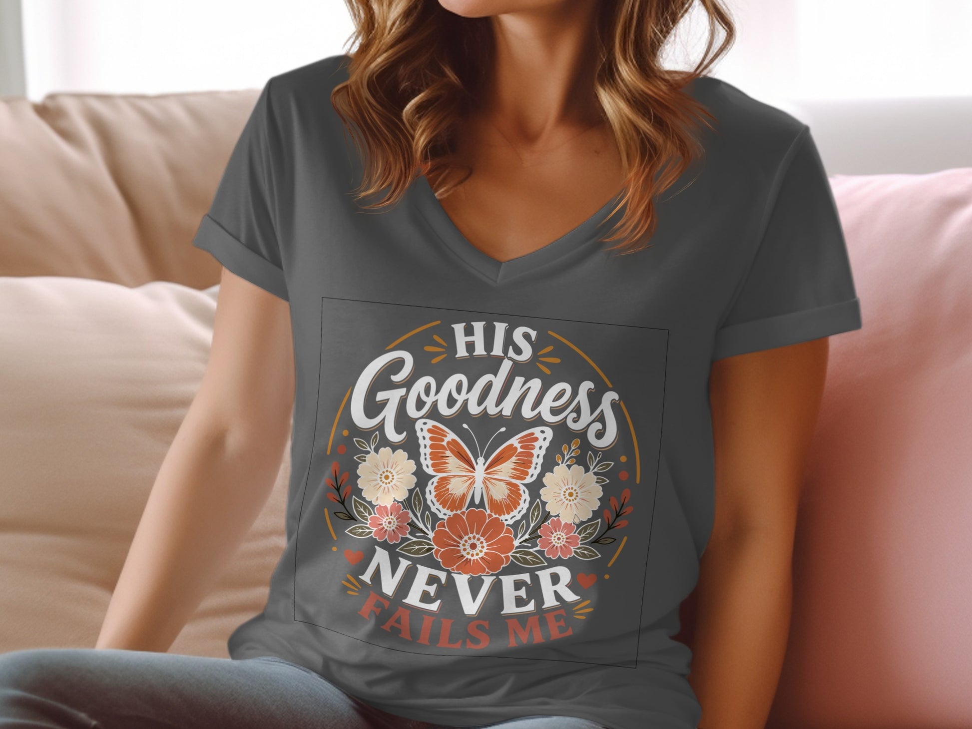 Dark grey v-neck t-shirt with "HIS GOODNESS NEVER FAILS ME" text and floral design.