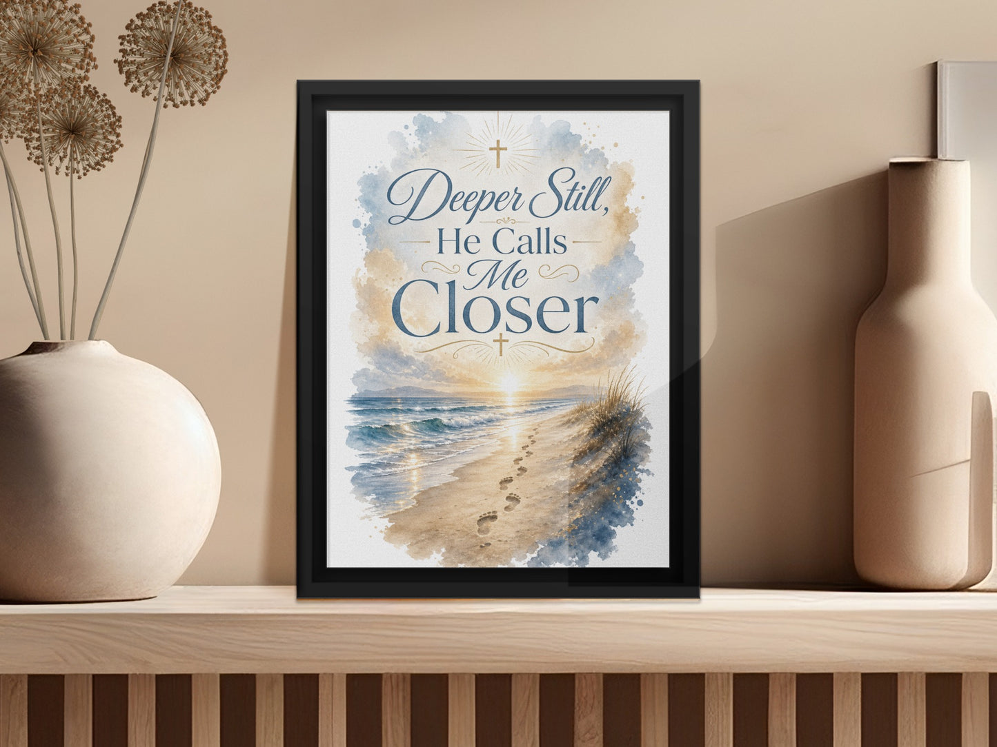 Framed artwork with text "Deeper Still, He Calls Me Closer" over beach scene.