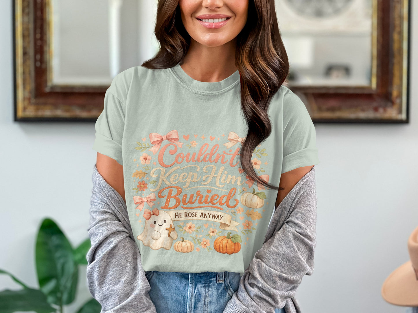 Light blue t-shirt with "Couldn't Keep Him Buried HE ROSE ANYWAY" text and cartoon ghost.