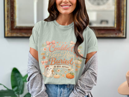 Light blue t-shirt with "Couldn't Keep Him Buried HE ROSE ANYWAY" text and cartoon ghost.