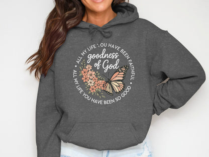 Dark gray hoodie with "Goodness of God" text and butterfly graphic.
