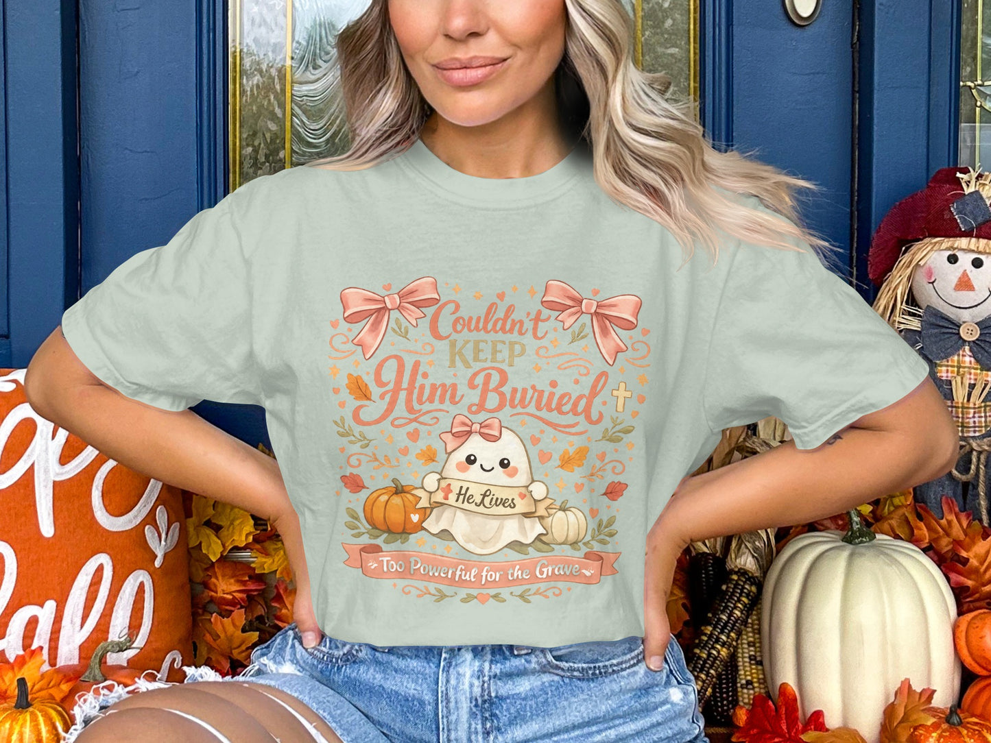 Light mint t-shirt with ghost graphic: "Couldn't Keep Him Buried, He Lives Too Powerful for the Grave."