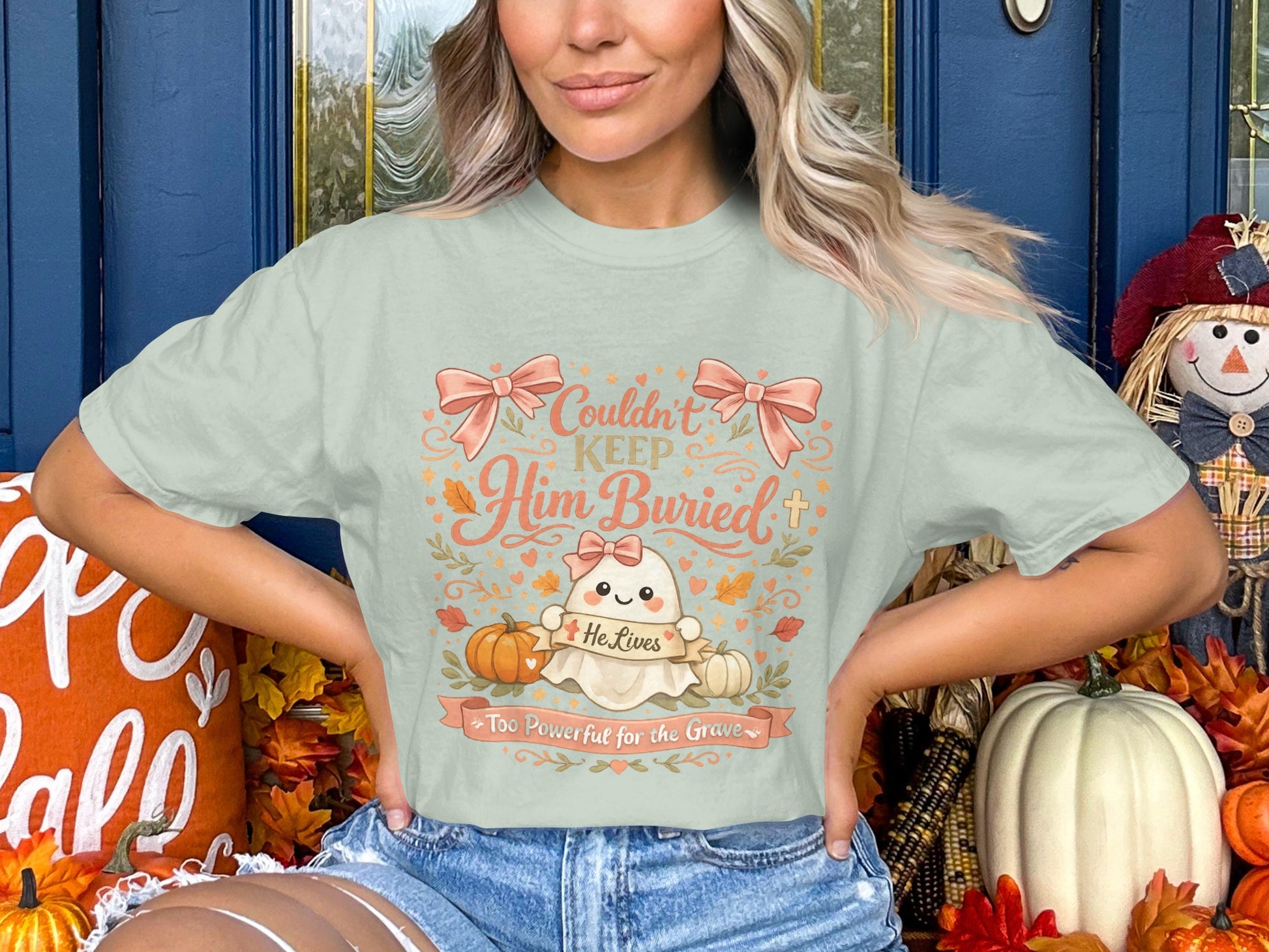 Light mint t-shirt with ghost graphic: "Couldn't Keep Him Buried, He Lives Too Powerful for the Grave."