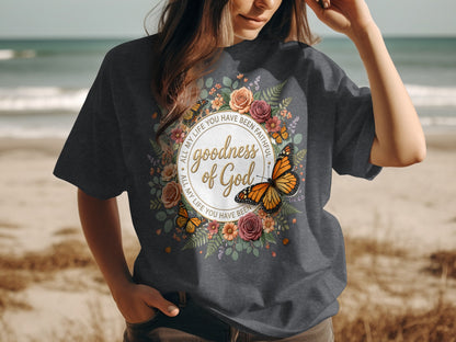 T-shirt with floral and butterfly design, featuring "Goodness of God" text.