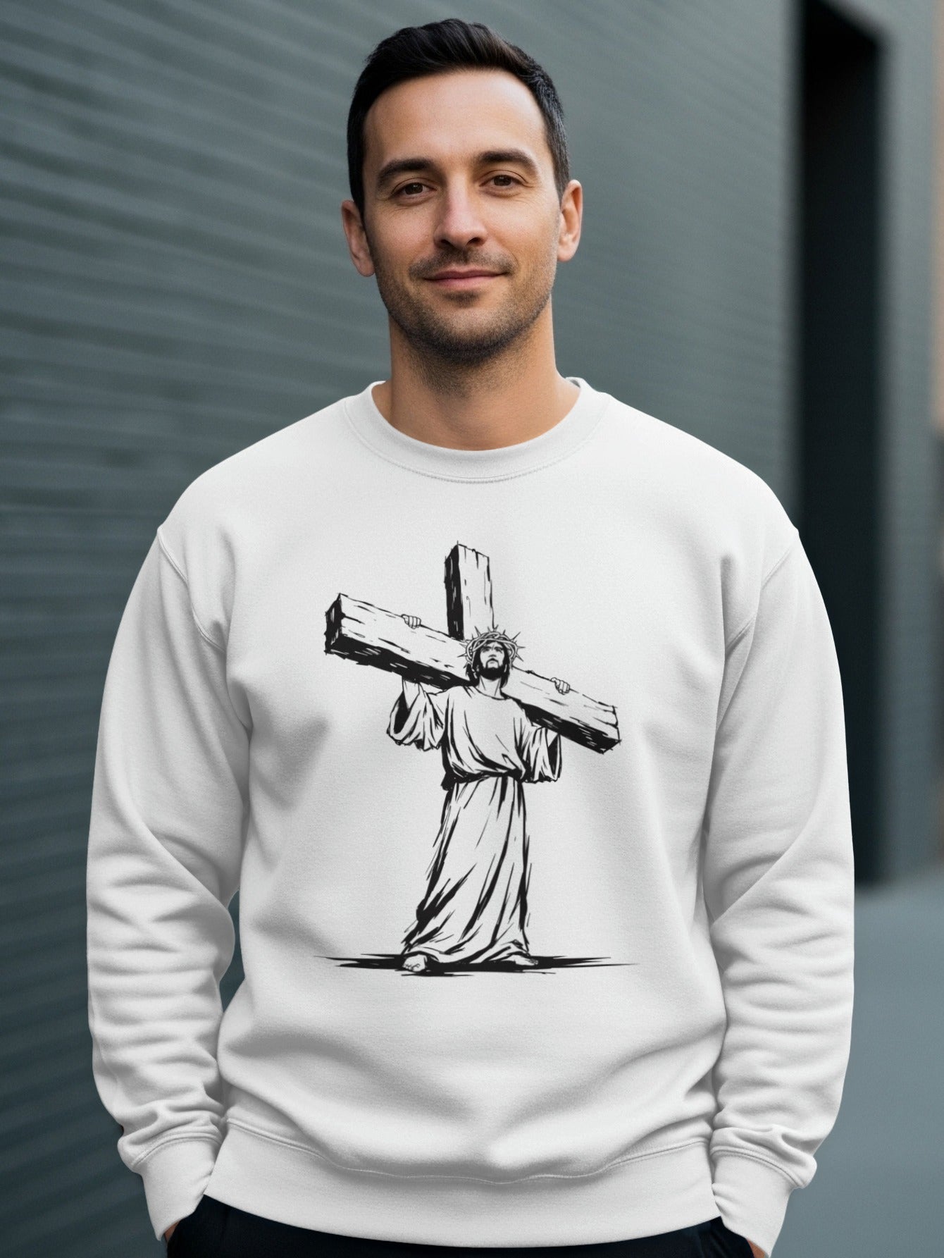 White sweatshirt with Jesus carrying the cross graphic.