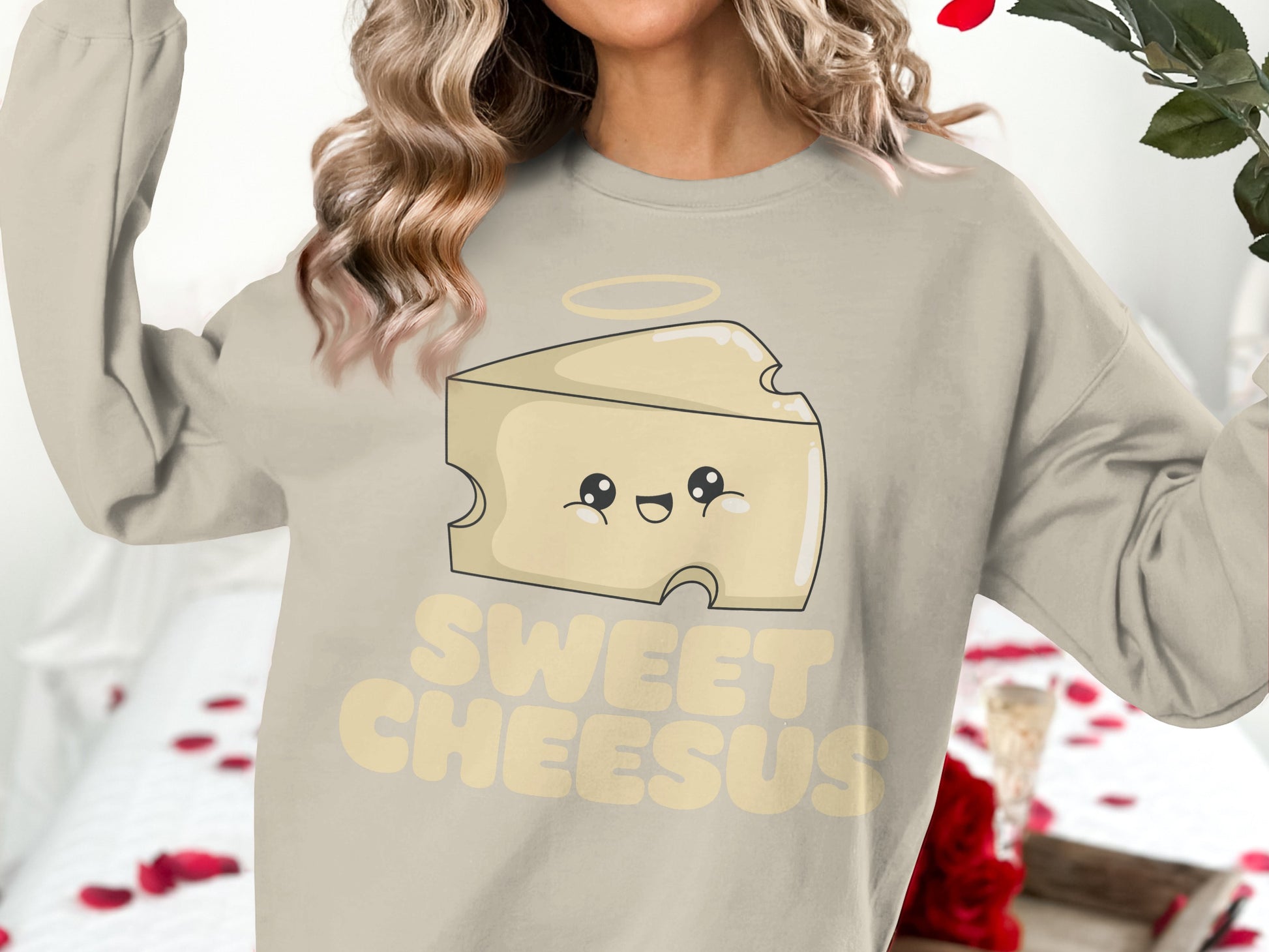 Cream sweatshirt with "Sweet Cheesus" text and a smiling cheese wedge graphic.