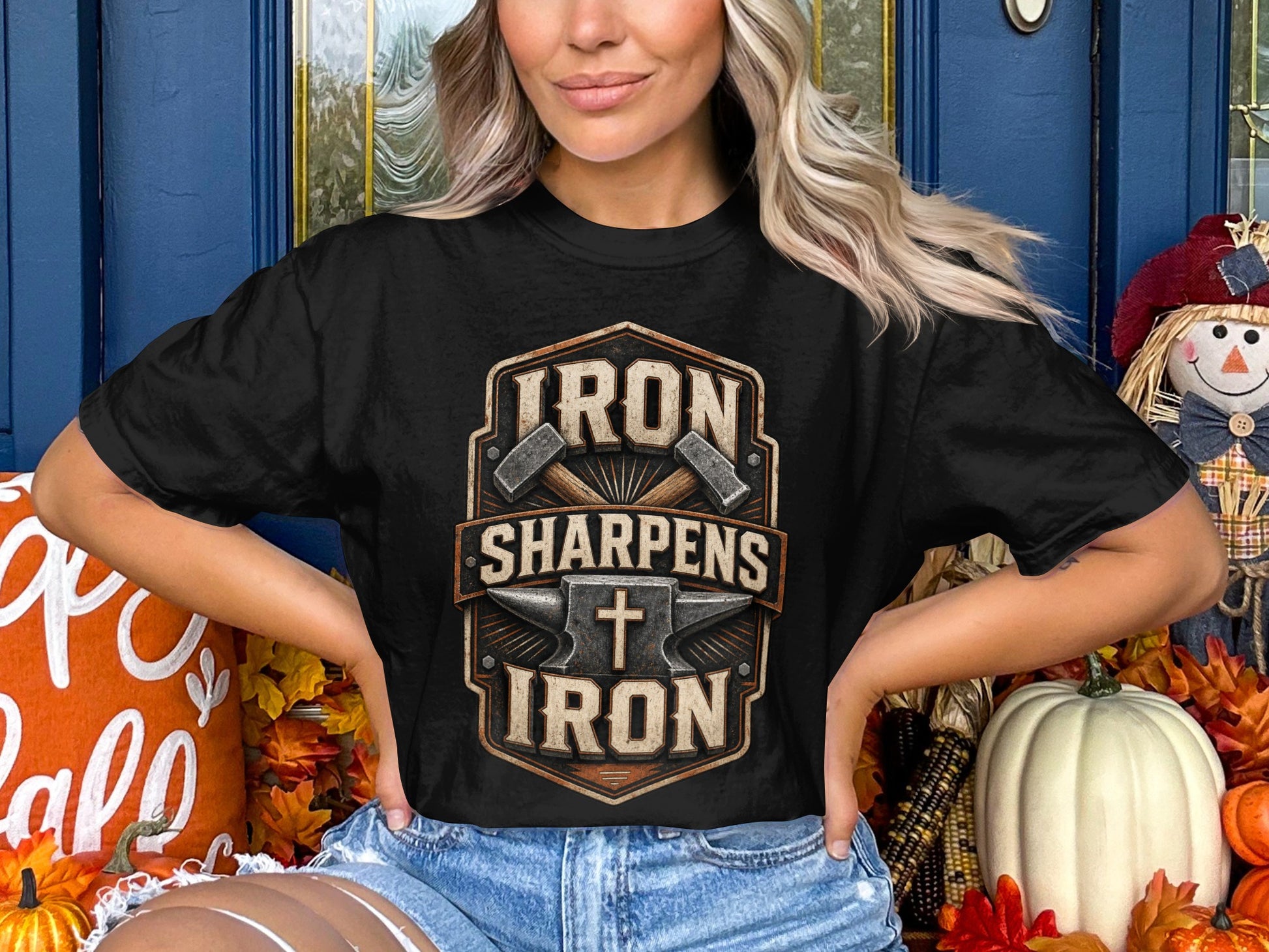 Black t-shirt with "Iron Sharpens Iron" text, anvil, hammers, and cross graphic.