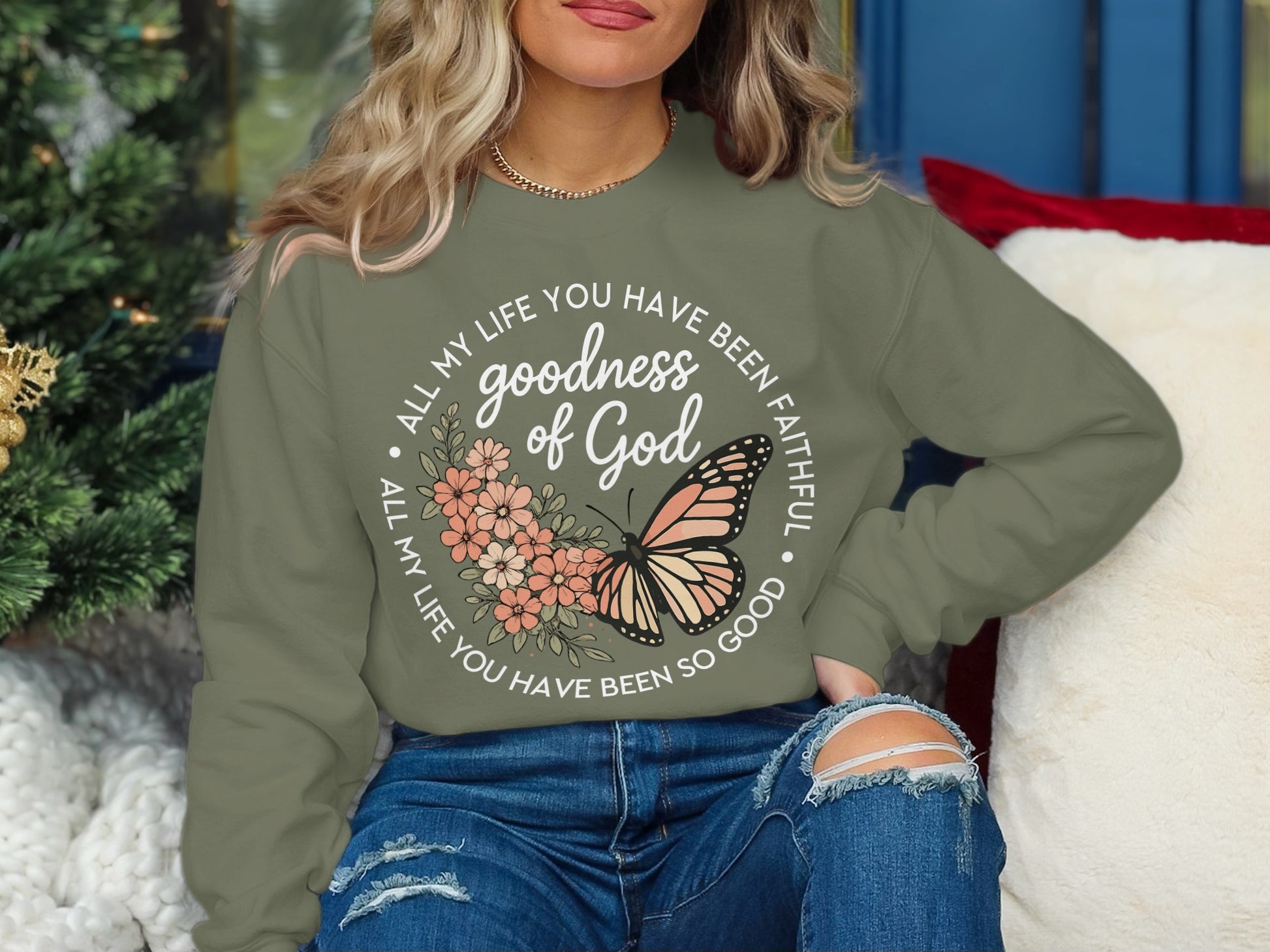Olive green sweatshirt with "goodness of God" and butterfly graphic.