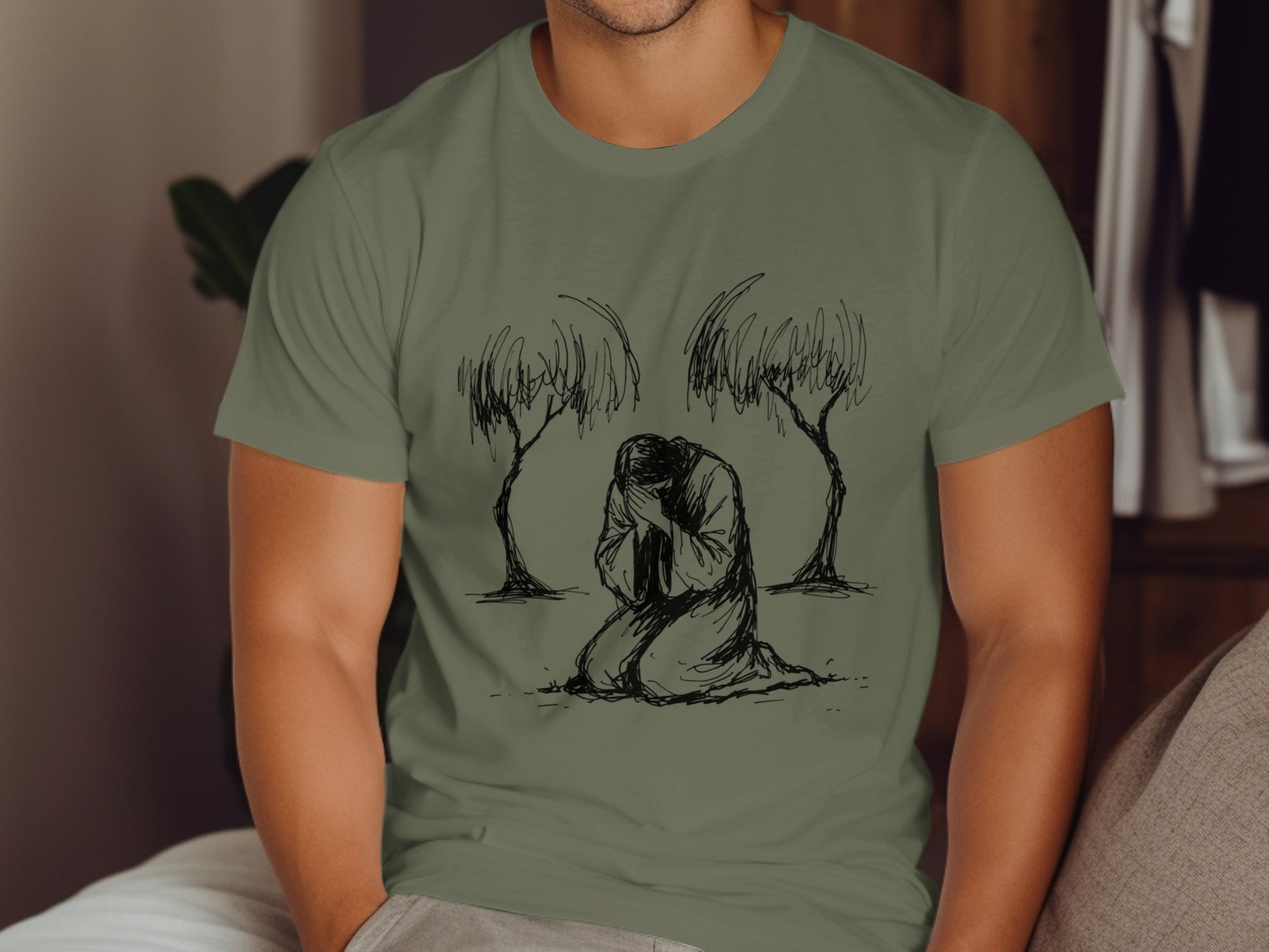 Line drawing of Jesus praying in Gethsemane on a olive green t-shirt.