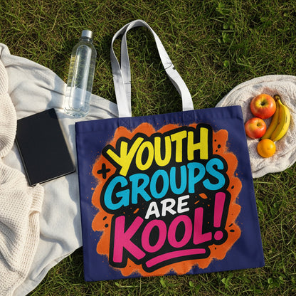 Navy tote bag with text "YOUTH GROUPS ARE KOOL!" on grass with fruit.