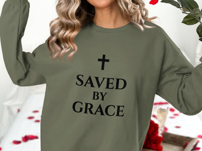 Olive sweatshirt with "Saved by Grace" and a cross graphic.