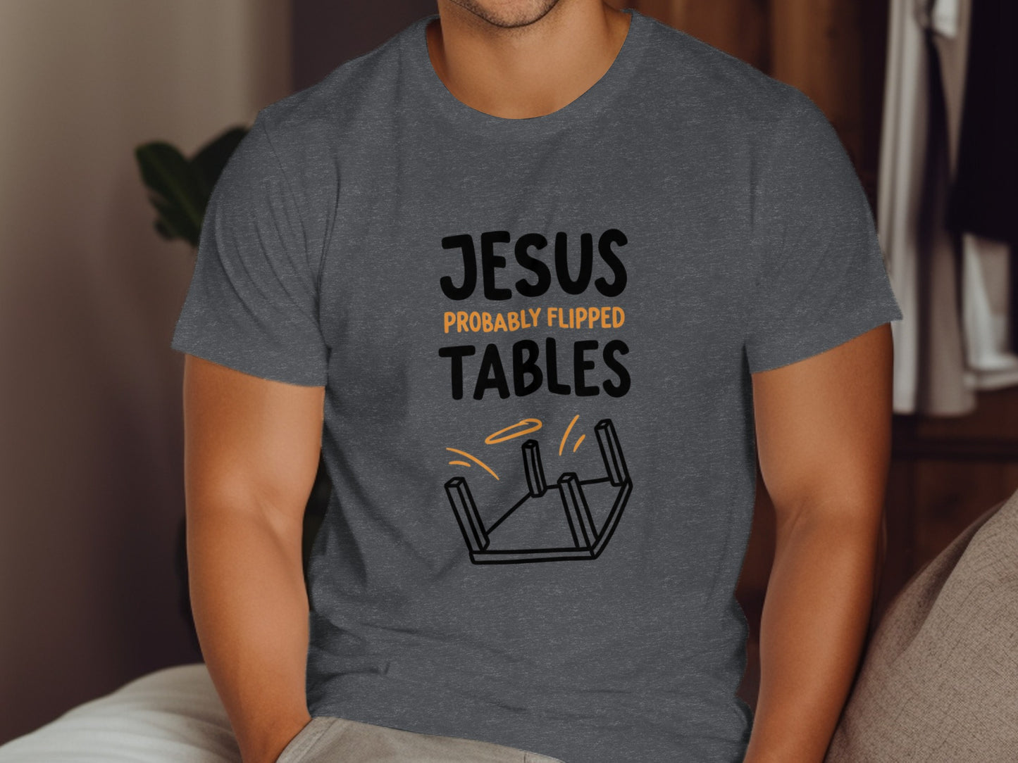 Dark gray t-shirt with "JESUS PROBABLY FLIPPED TABLES" text and overturned table graphic.