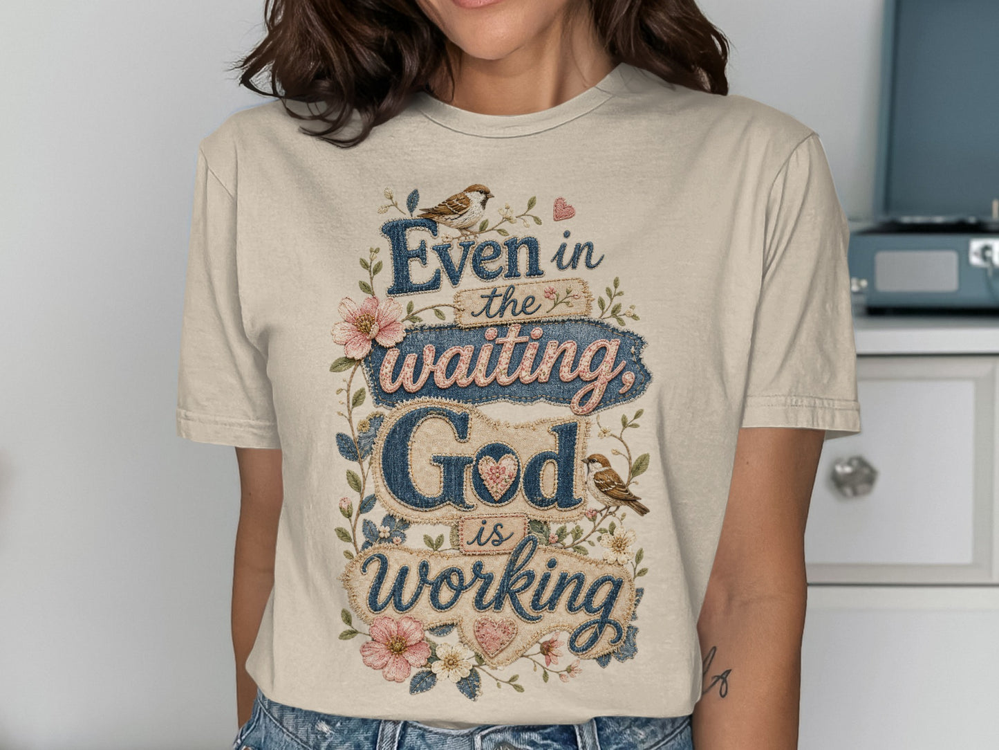 Beige t-shirt with "Even in the waiting God is working" quote.