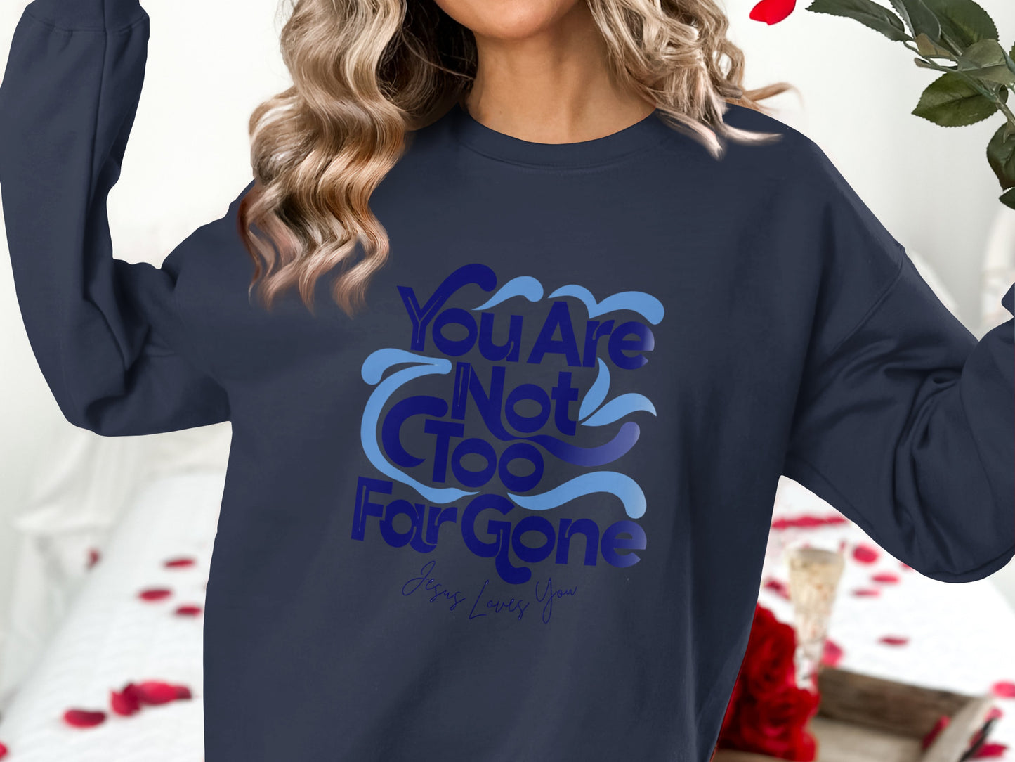 Navy sweatshirt with "You Are Not Too Far Gone" and "Jesus Loves You" text.