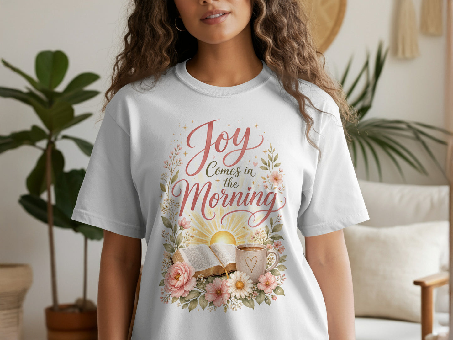 White t-shirt with text "Joy Comes in the Morning" and floral design.