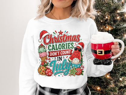 Christmas calories don't count in July graphic on a white sweatshirt.
